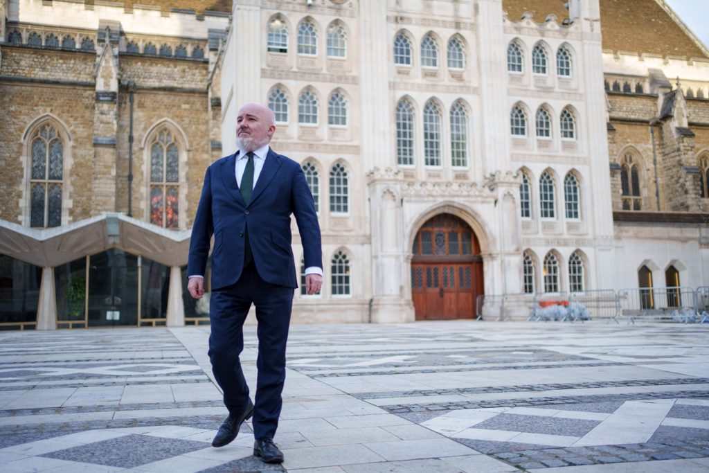 Mark Glover walking across courtyard